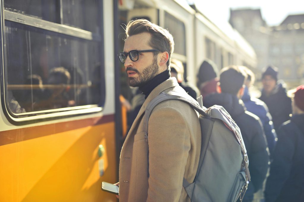 pexels-photo-837358-837358 A stylish man with a backpack boards a tram in bustling Budapest, Hungary, during the day.